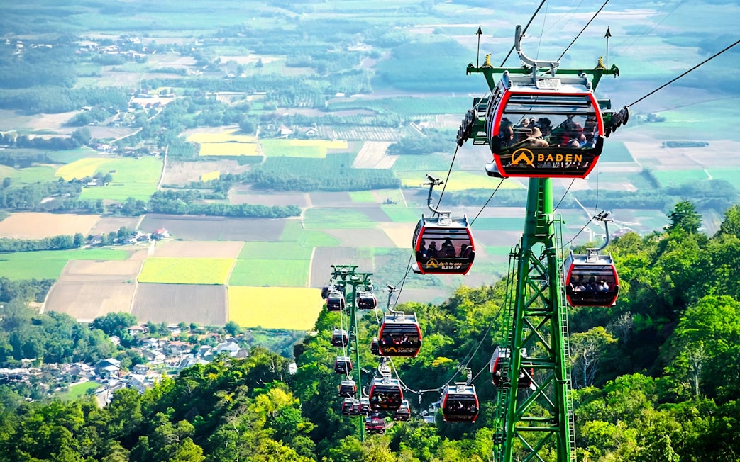 Cable cars ascending Ba Den Mountains with scenic landscape views.