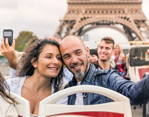 Tourist sitting in the open top Big Bus Paris Hop on Hop off bus