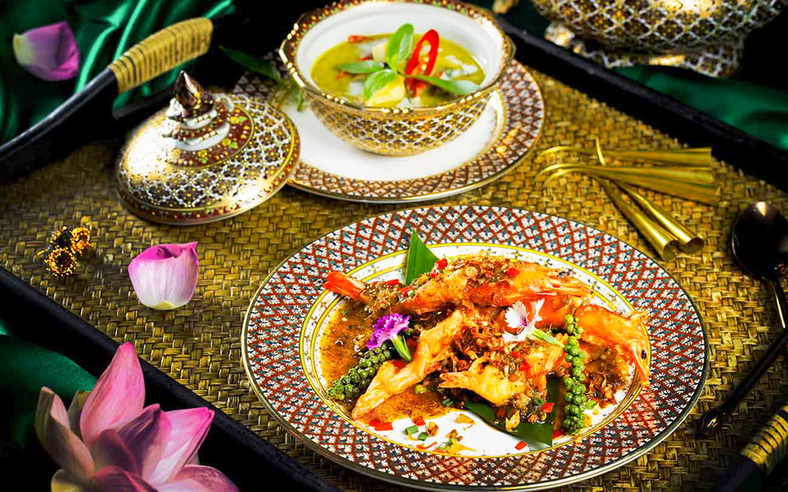 Traditional Thai dishes served on ornate plates during Manohra Dinner Cruise.