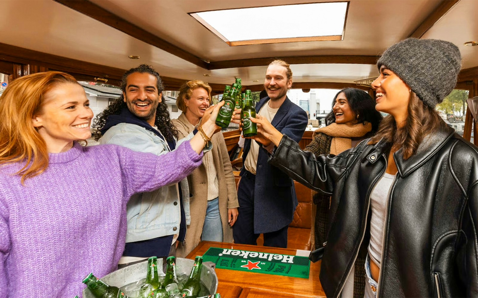 Guests on Heineken Flagship Canal Cruise in Amsterdam enjoying premium beer.