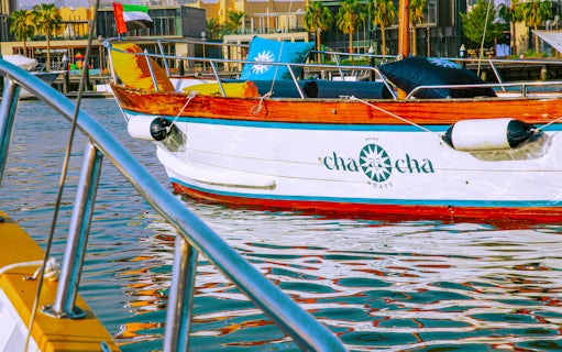 Boat docked in Jumeirah marina with UAE flag, part of Jumeirah Swimming Tour.
