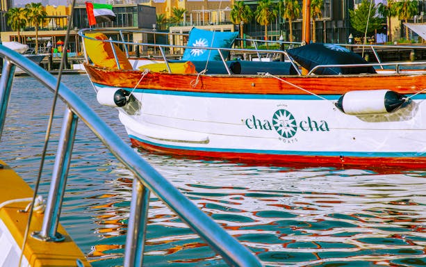 Boat docked in Jumeirah marina with UAE flag, part of Jumeirah Swimming Tour.