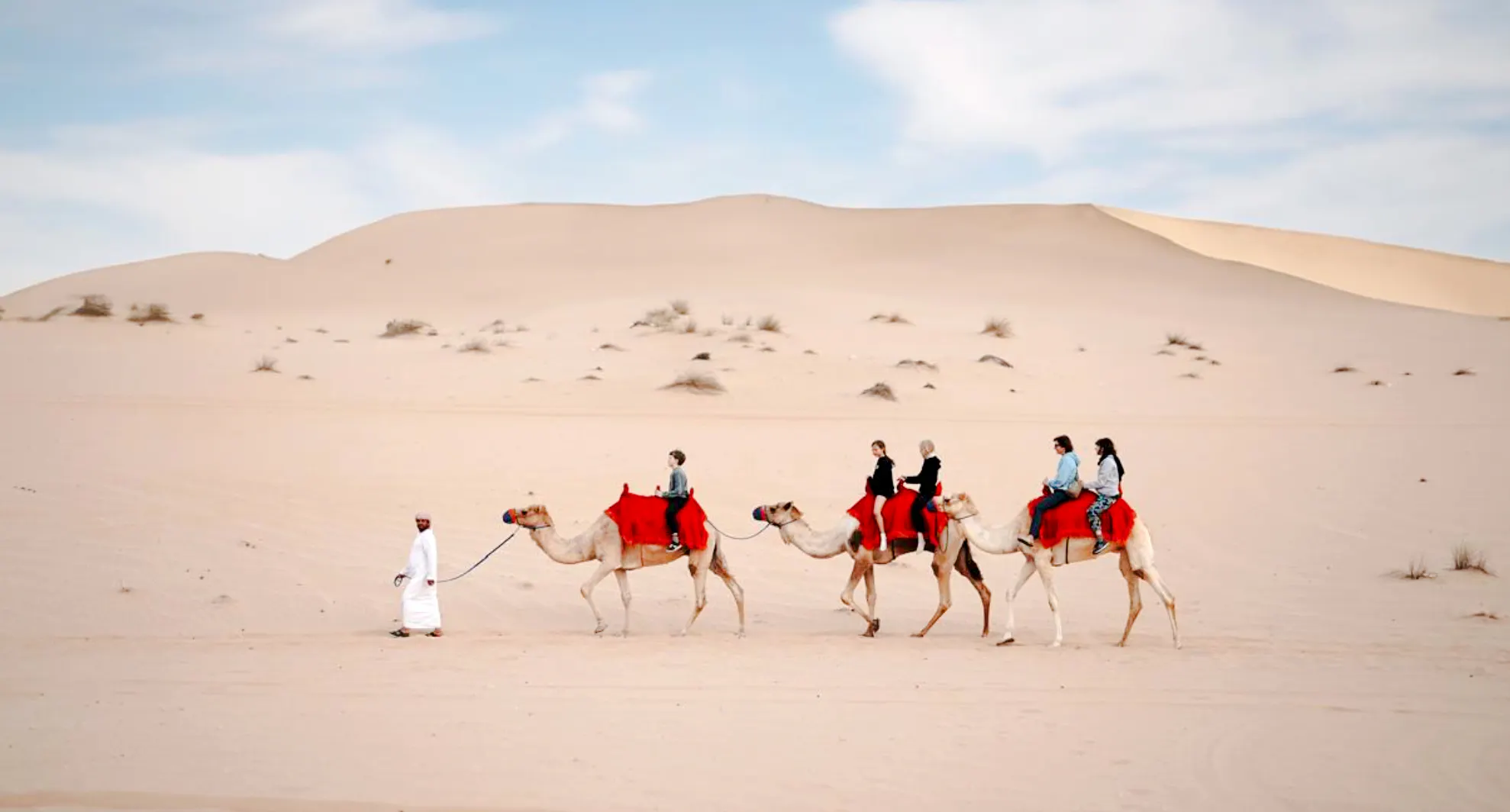 Camel ride in Abu Dhabi desert during evening safari.