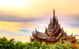 Sanctuary of Truth temple by the sea during sunset, Pattaya city tour.