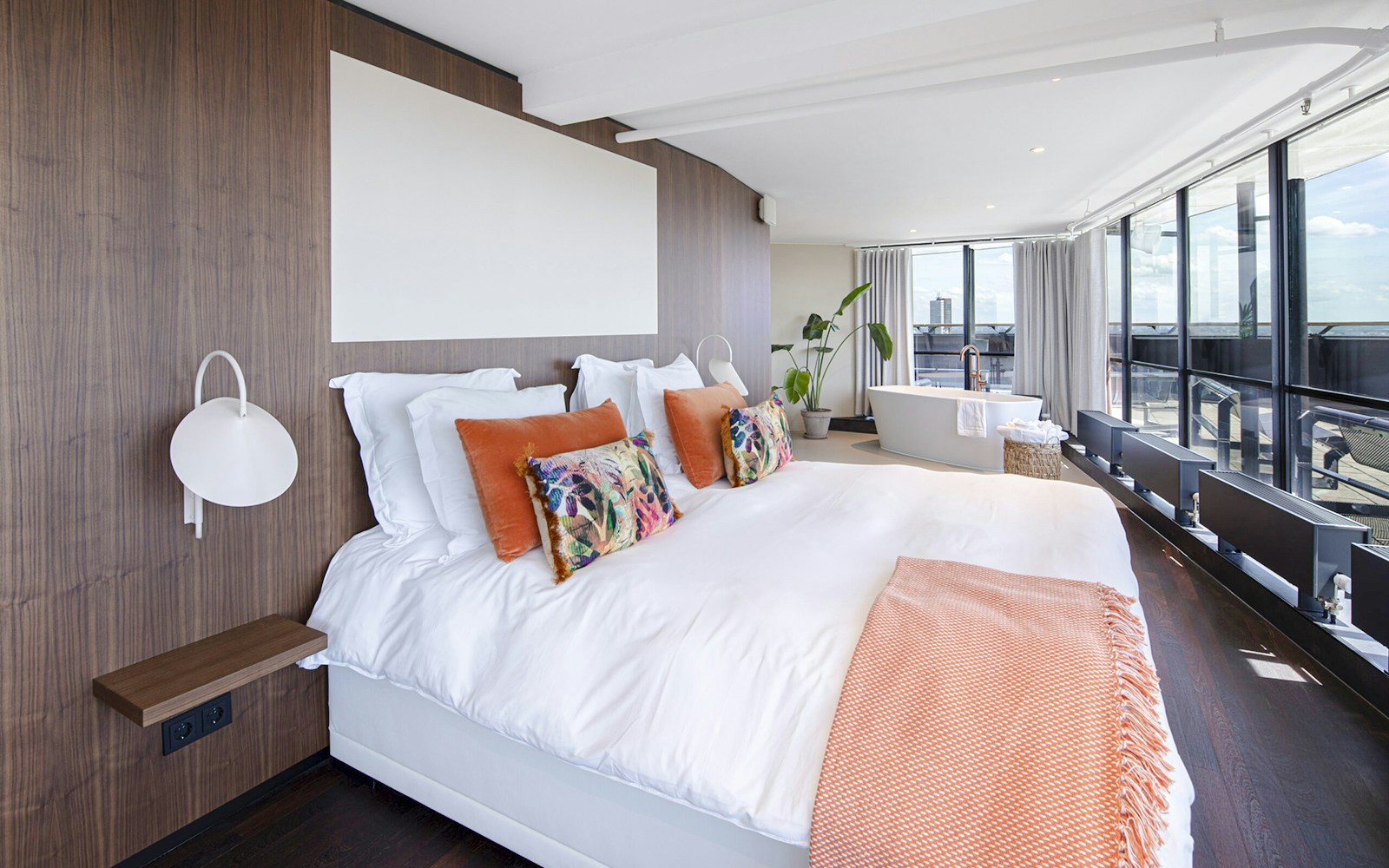 Luxurious suite with large bed and bathtub at Euromast, Rotterdam.