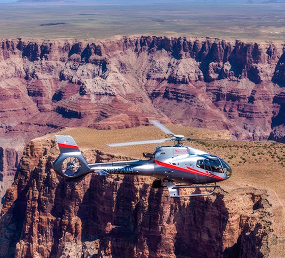 Maverick helicopter flying over the Grand Canyon.