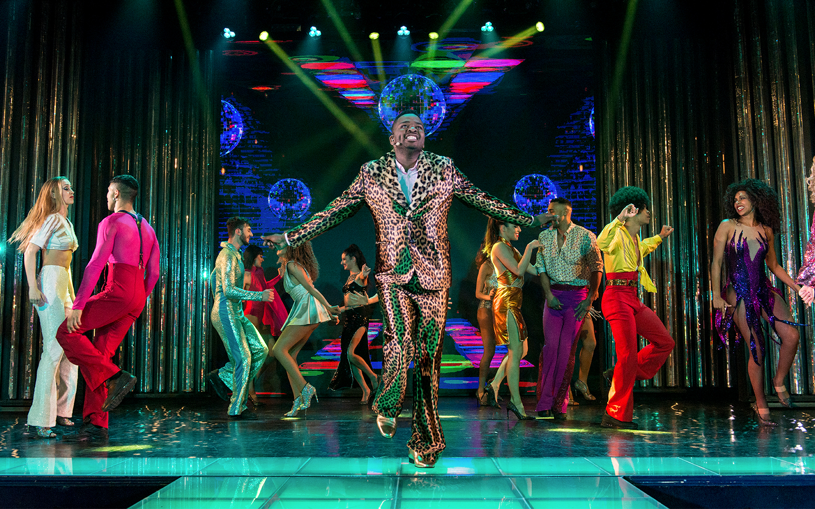 Paradis Latin cabaret show with performers in vibrant costumes, Birds of Paradis theme, Paris, France.