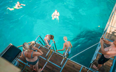 Guests swimming from boat during Alanya Day Tour.