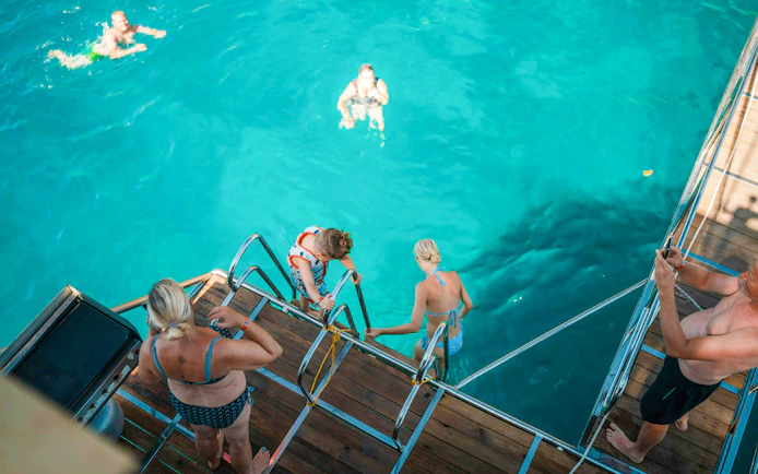 Guests swimming from boat during Alanya Day Tour.