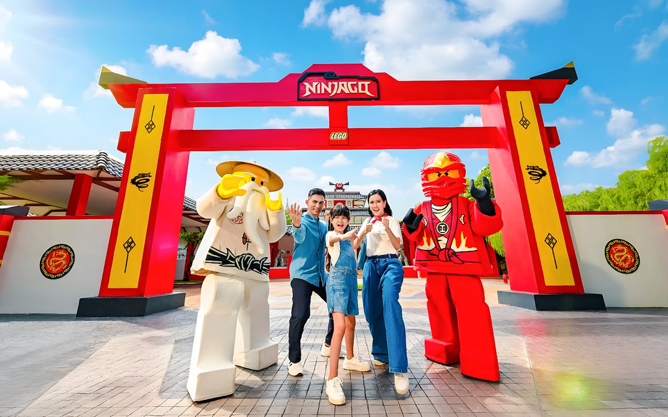 Family posing with Lego Ninjago figures at LEGOLAND Malaysia Theme Park.