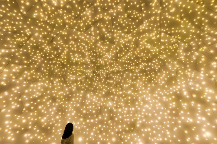 TeamLab art installation with floating spheres in Abu Dhabi exhibition space.