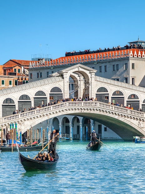 Gondolas on the Grand Canal near Rialto Bridge, Venice.