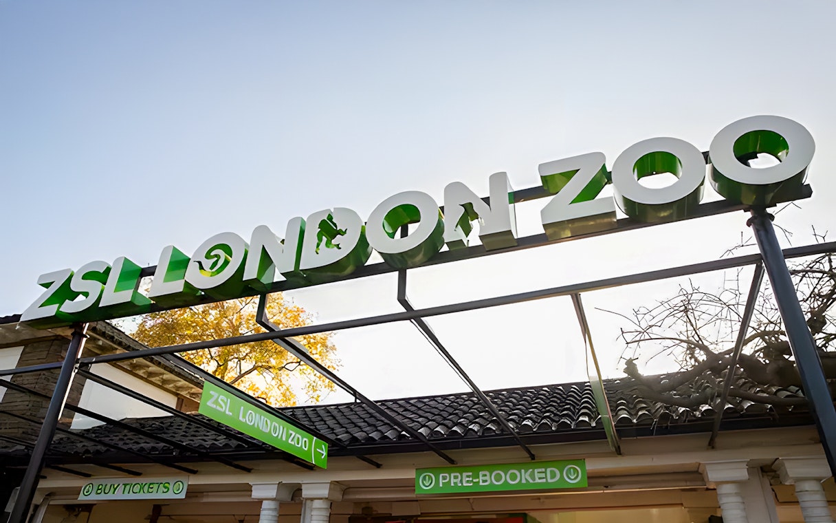 ZSL London Zoo entrance sign with ticket booths below.