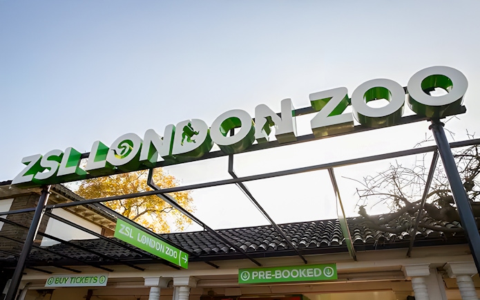 ZSL London Zoo entrance sign with ticket booths below.