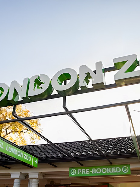 ZSL London Zoo entrance sign with ticket booths below.