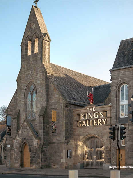 King's Gallery entrance at Palace of Holyroodhouse, Edinburgh, with flags and historic architecture.