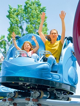 Family enjoying a ride at an amusement park.