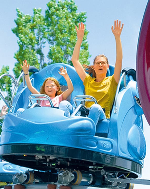 Family enjoying a ride at an amusement park.