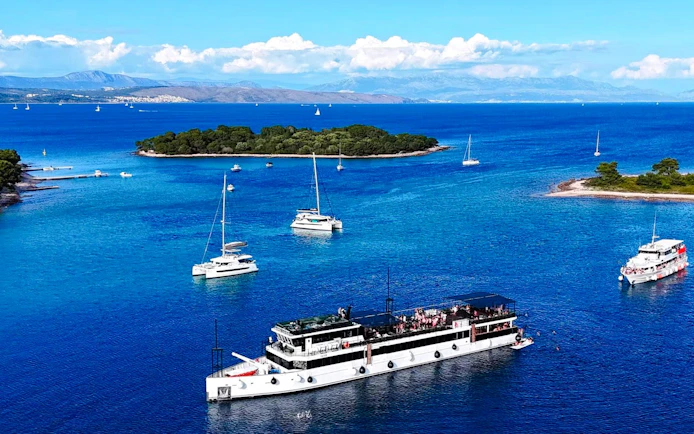 Yacht sailing near Blue Lagoon with islands in the background during Split party tour.