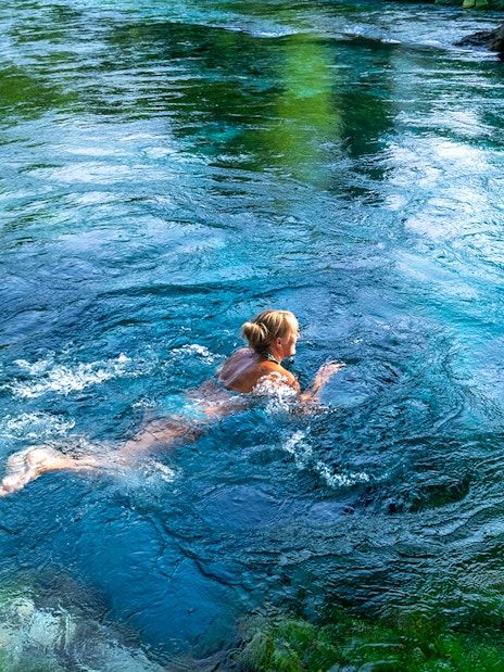Tourist swimming in the Blue Eye waters, Albania.