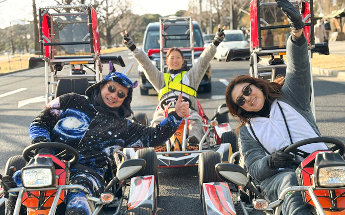 People in costumes driving go-karts on a street in Ginza, Tokyo.