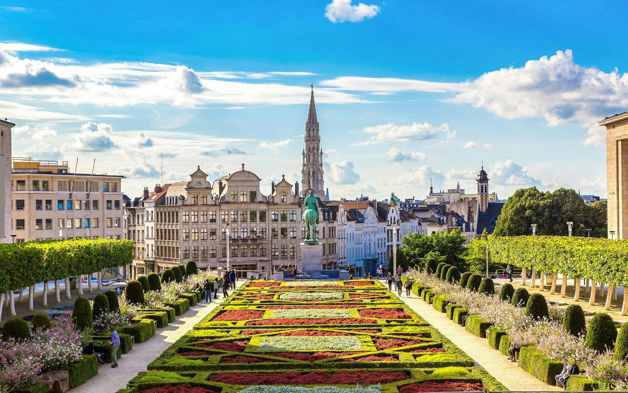 Mont des Arts garden with colorful flower beds and Brussels skyline in Belgium.
