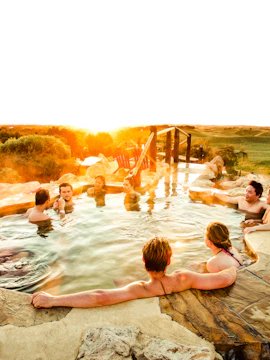 People relaxing in a hot spring at sunset on Mornington Peninsula.