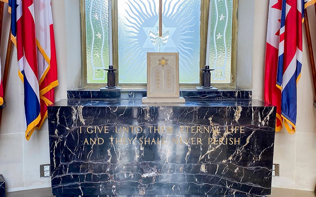 Memorial altar with flags at Normandy American Cemetery, D-Day Normandy Beaches Day Trip.