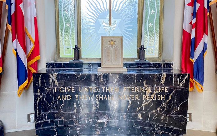 Memorial altar with flags at Normandy American Cemetery, D-Day Normandy Beaches Day Trip.