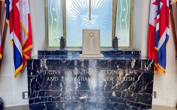 Memorial altar with flags at Normandy American Cemetery, D-Day Normandy Beaches Day Trip.