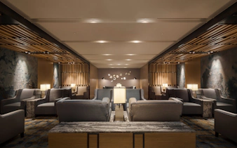 Seating area in Plaza Premium Lounge, Zone C, Taipei, Taiwan with modern decor and ambient lighting.