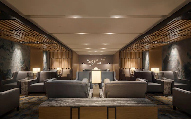 Seating area in Plaza Premium Lounge, Zone C, Taipei, Taiwan with modern decor and ambient lighting.