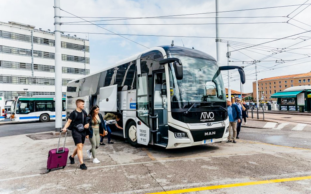 Passengers boarding ATVO airport transfer bus in Venice.