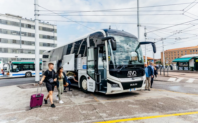 Passengers boarding ATVO airport transfer bus in Venice.