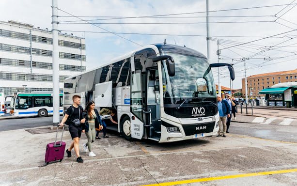 Passengers boarding ATVO airport transfer bus in Venice.