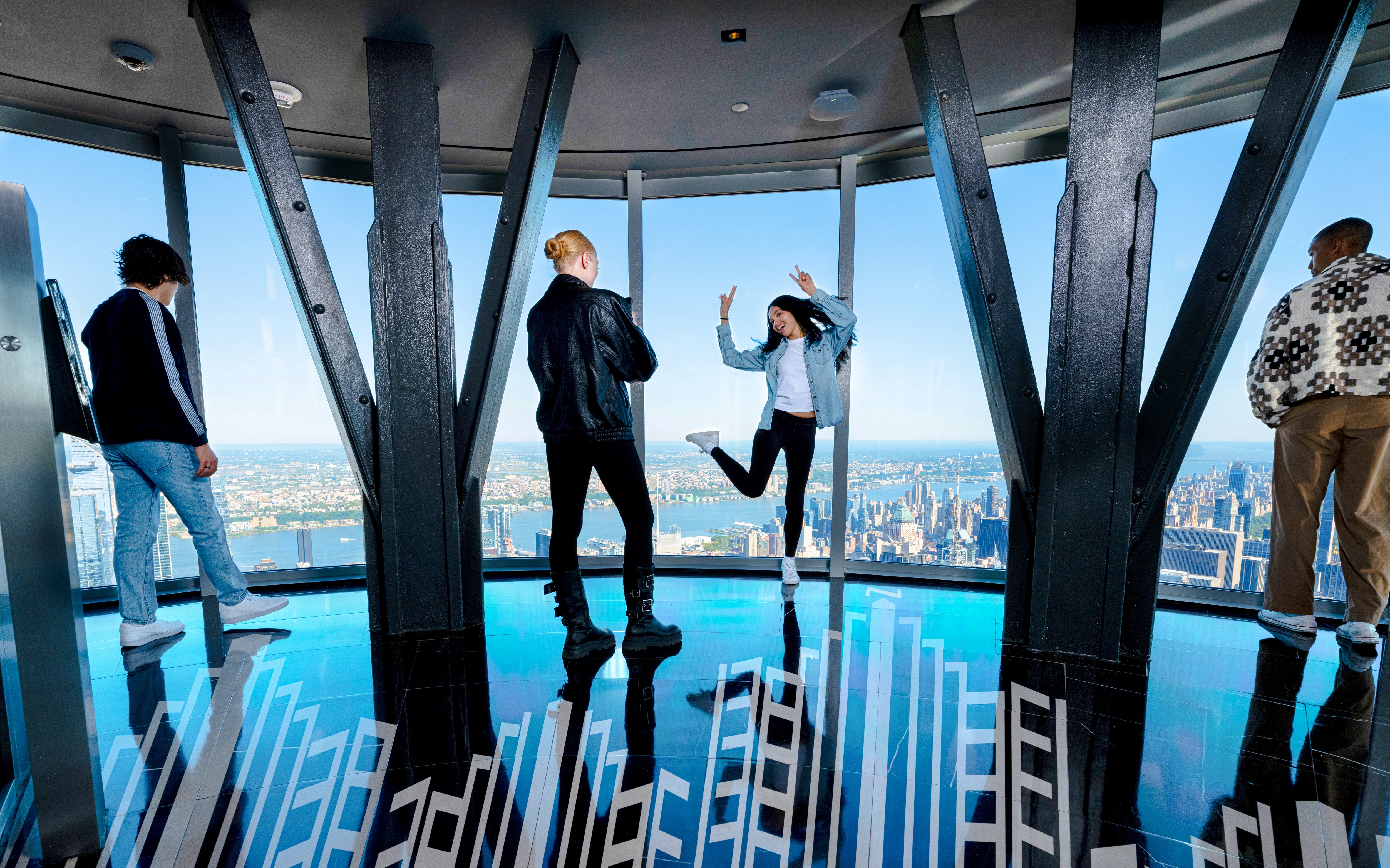 Guests enjoying the view from the 102nd floor of the Empire State Building in New York.