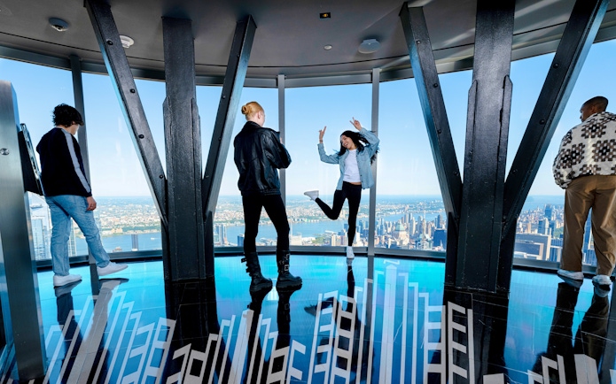 Guests enjoying the view from the 102nd floor of the Empire State Building in New York.