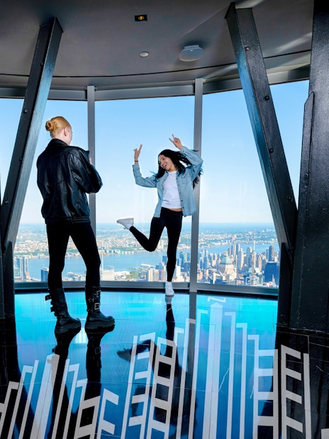 Guests enjoying the view from the 102nd floor of the Empire State Building in New York.