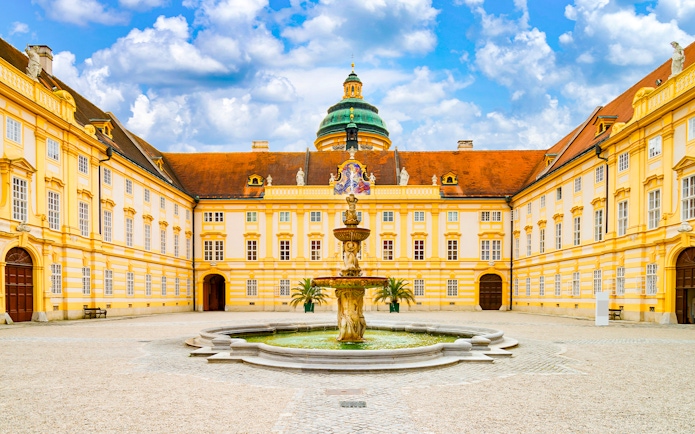 Melk Abbey courtyard with fountain, Danube Valley day trip from Vienna.