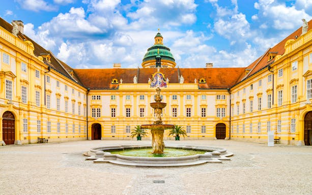 Melk Abbey courtyard with fountain, Danube Valley day trip from Vienna.