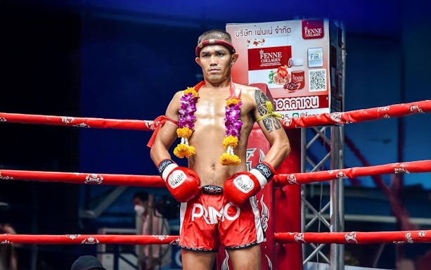 Muay Thai fighter in the ring at Rawai Muay Thai Boxing Camp, wearing traditional garlands.
