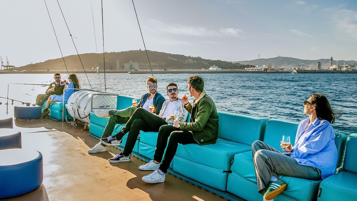 Group of tourists enjoying a sunny day on a Catamaran Premium cruise in the beautiful waters of Barcelona