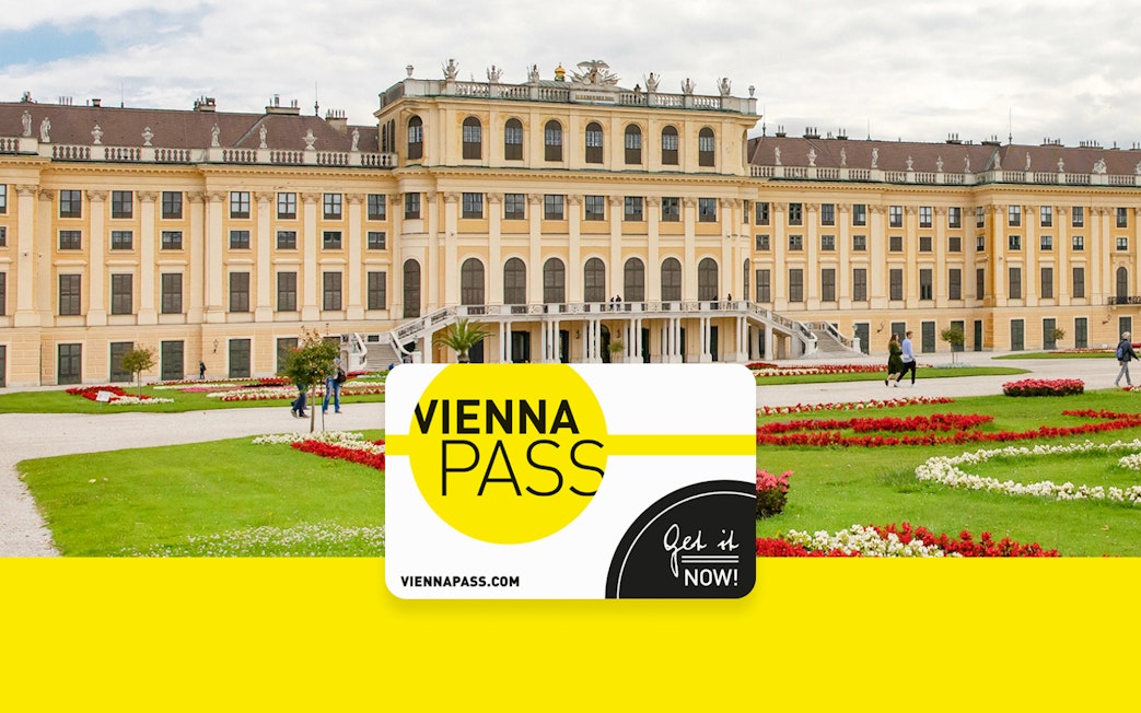 Vienna Pass card in front of Schönbrunn Palace, Vienna, with gardens and visitors.