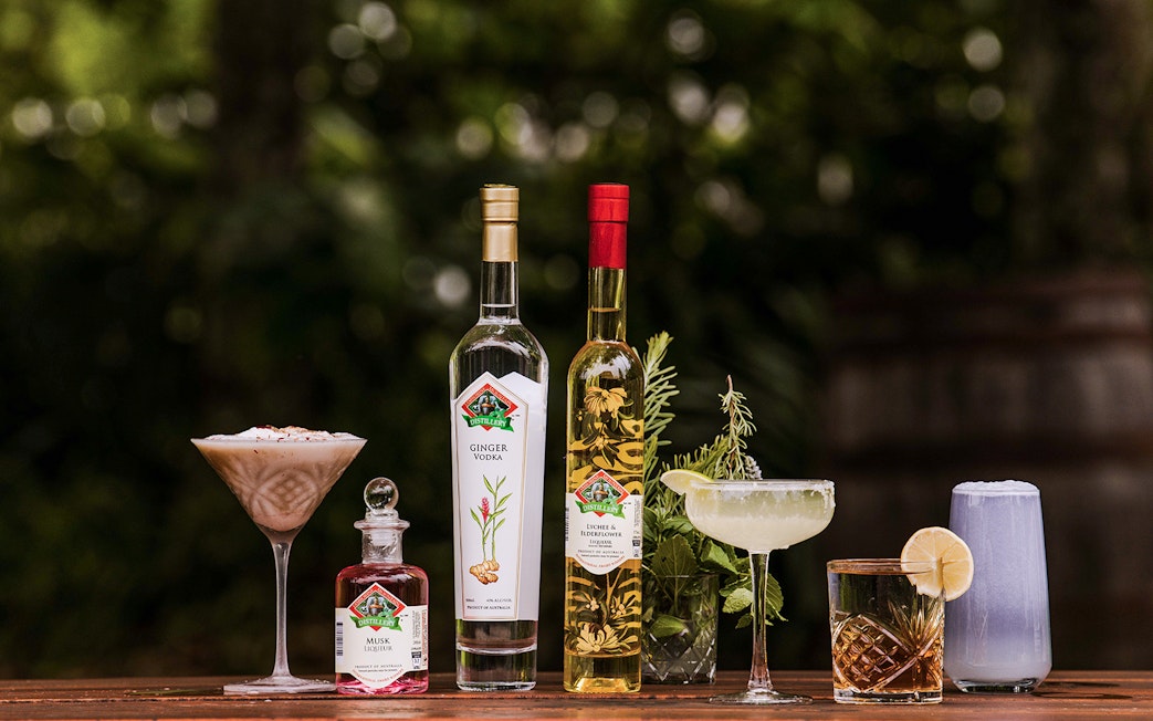 Assorted drinks and spirits from Tamborine Mountain distillery on a wooden table.