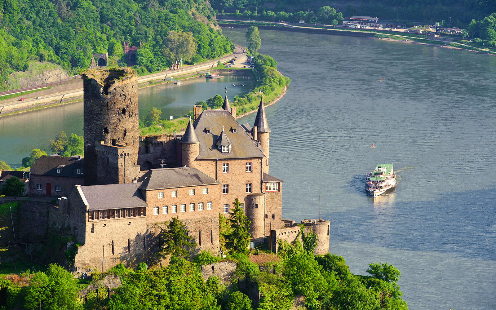 Paddle steamer Goethe cruising past a historic castle on the Rhine River.
