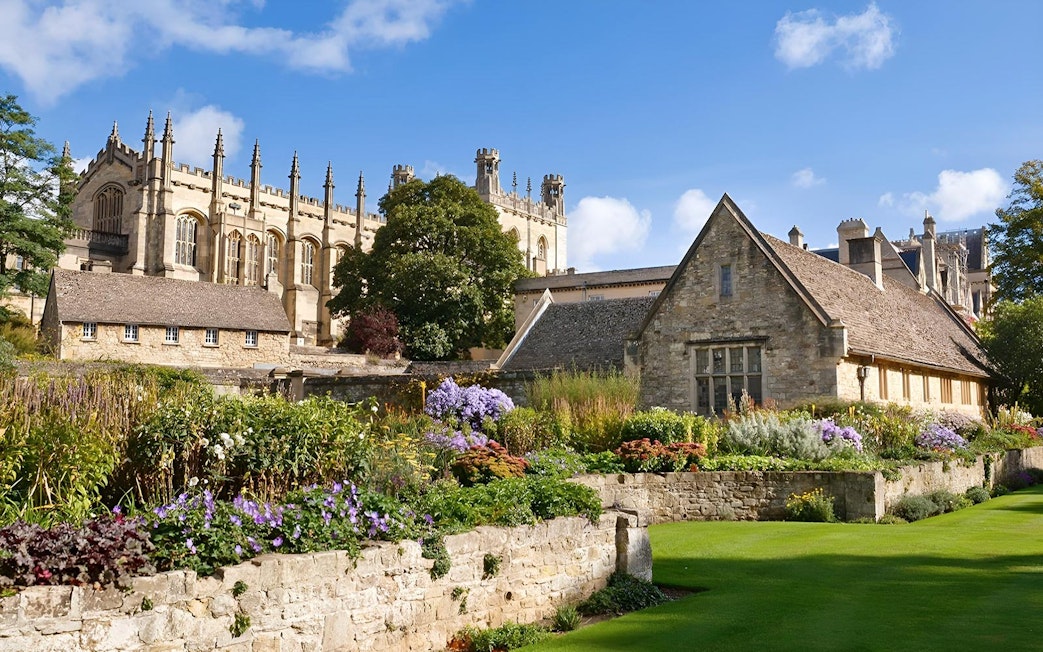 Historic Oxford college buildings with gardens, part of the Oxford by Rail day tour from London.
