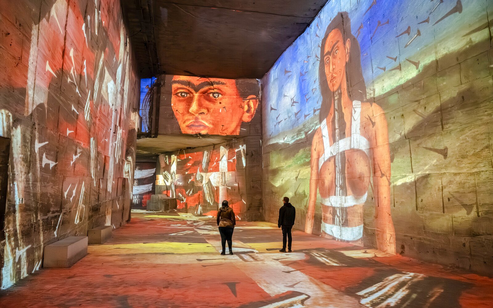 Frida Kahlo artwork projected on walls at Carrières des Lumières exhibit.