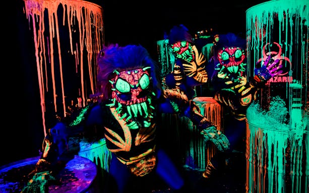 Halloween-themed creatures in neon colors at Astérix Parc special event.