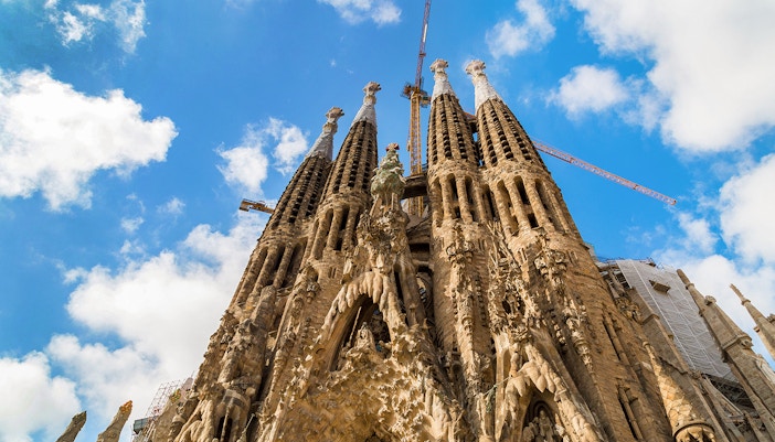 Sagrada Familia facade with intricate stone carvings and spires in Barcelona, Spain.