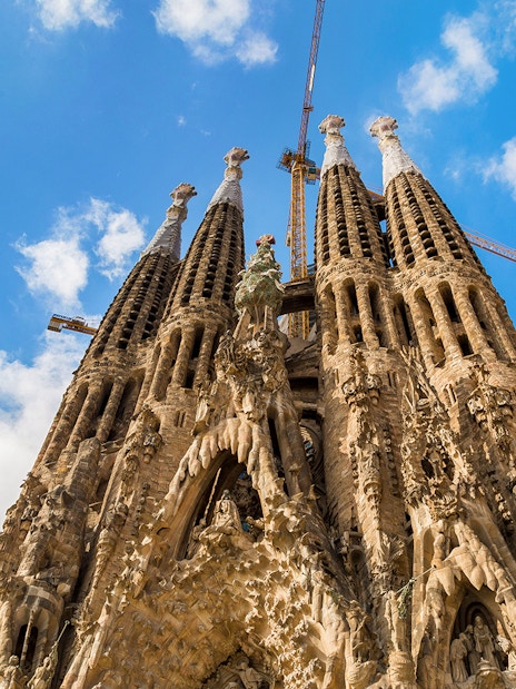 Sagrada Familia facade with intricate stone carvings and spires in Barcelona, Spain.